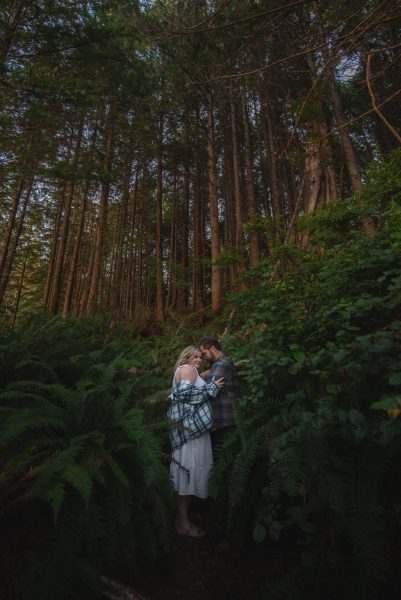couple taking elopement photos in the forest in Tofino