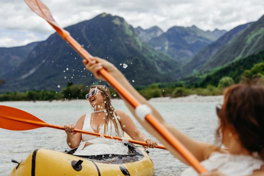 Lesbian couple eloping with pack rafts on the Soča river in Slovenia