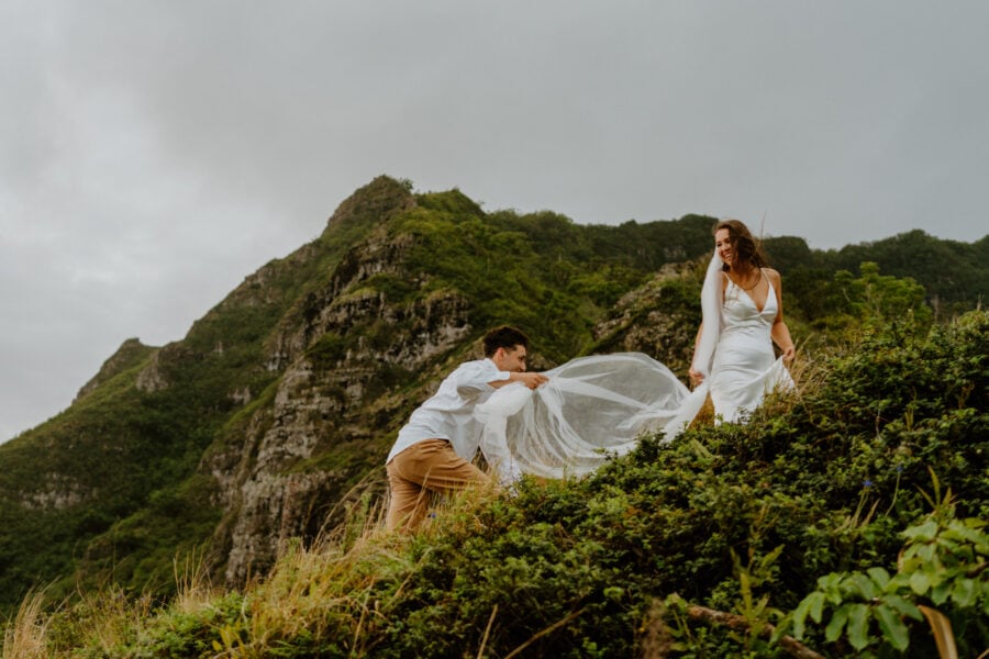 Bride and groom eloping in Oahu on a mountain range.