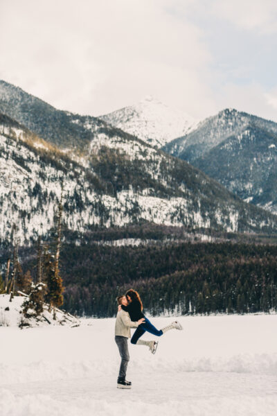Couple Iceskate on mountain lake