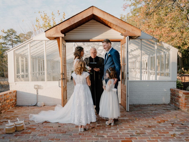 photo of elopement ceremony in front of a glass building