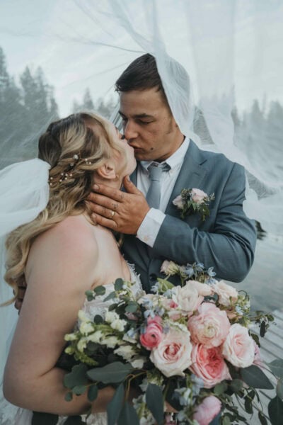 Couple kissing under the veil in Canmore