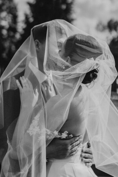 Couple kissing under the veil black and white Alberta