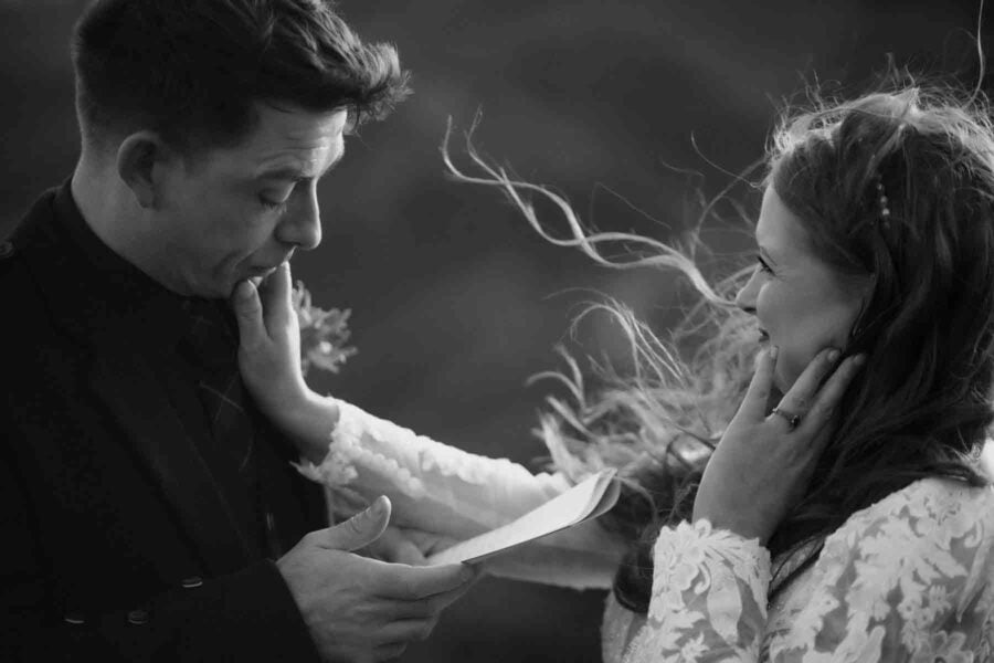 Couple exchanging vows, bride wiping away grooms tears
