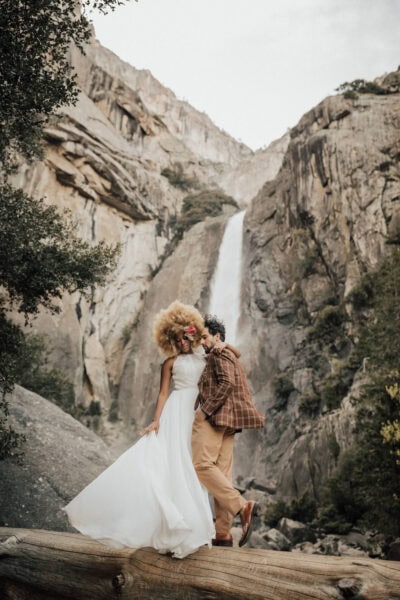 omantic Yosemite photo of the bride and groom sharing a kiss in a misty meadow.