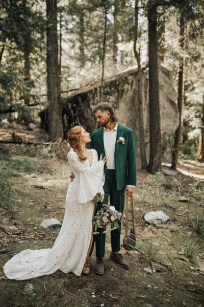 Adventurous bride hiking in her wedding dress along a scenic Yosemite trail