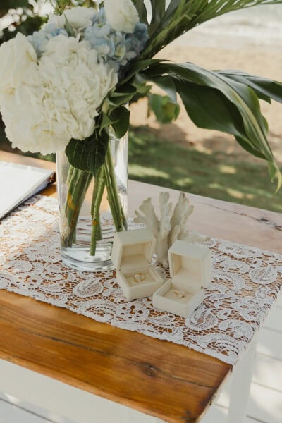 Flowers and wedding rings in their boxes