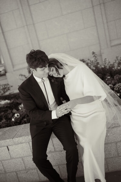 Man and Woman sitting and cuddling together before getting married, looking at their wedding rings