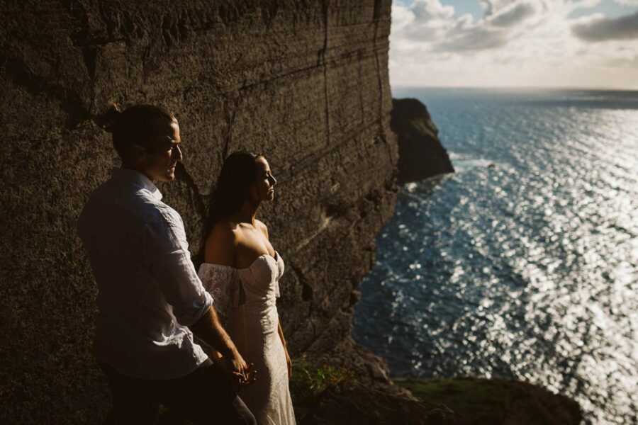 Couple eloping on cliffs at sunset in Ireland