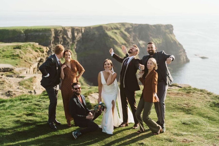 Couple eloping on cliffs in Ireland with all their friends