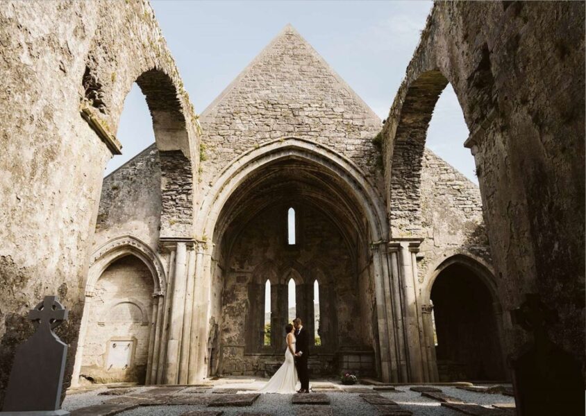 Couple eloping in Ireland in an abbey ruin