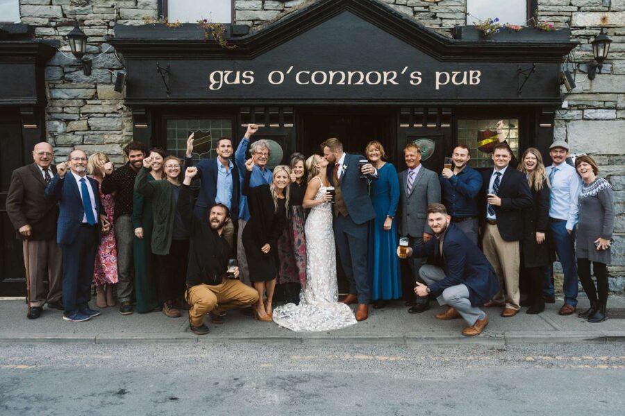 Group in front of Irish pub with guinness after eloping in Ireland