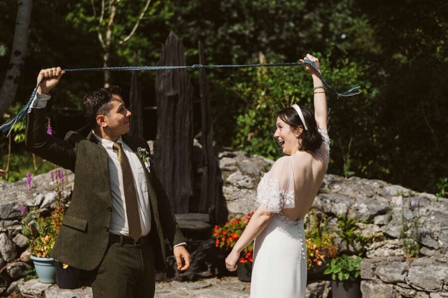 A couple tying the knot at their ceremony while eloping in Ireland